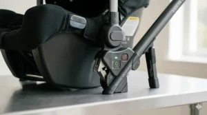 Close-up illustration of the secure locking mechanism on a double stroller car seat adapter for infant safety.