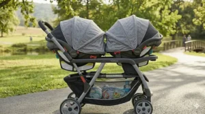 Two large adjustable UV-protective canopies extended over the seats of a Graco double stroller travel system.