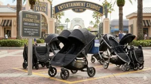 A photorealistic illustration showing the specific sleek double stroller neatly parked in a designated stroller parking zone with a Universal Studios informational sign.