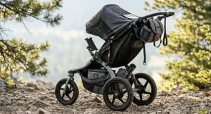 An all-terrain stroller featuring a large under-seat storage basket filled with outdoor gear and a diaper bag.