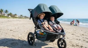 Two young children sitting comfortably in a double jogging stroller on a sunny Florida beach.
