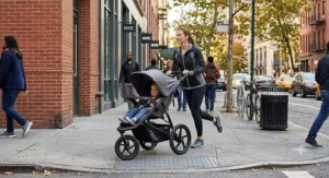 A parent maneuvering a swivel wheel jogging stroller smoothly around tight corners on a busy city sidewalk.