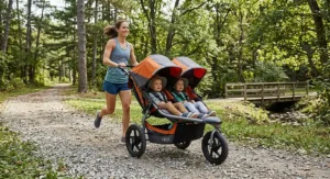 All-terrain jogging double stroller designed for running with twins on a gravel path
