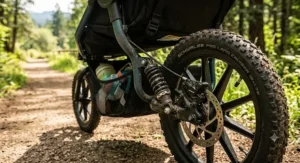 Close-up of air-filled tires and heavy-duty suspension on an all-terrain double jogging stroller