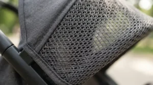 Detail view of the breathable mesh ventilation panels on an infant twin stroller for NICU graduate twins.