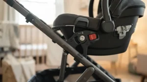 Detailed shot of the dual car seat adapter mechanism attached securely to an infant twin stroller frame.