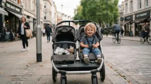 Sit-and-stand stroller with standing platform for older kids featuring a rear bench seat for a toddler