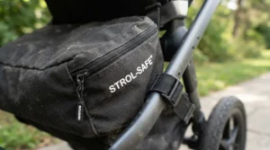 Demonstrating the water-resistant fabric of a twin travel stroller with included travel bag during outdoor sightseeing.