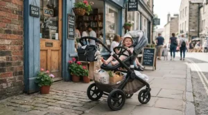 A single-to-double stroller for growing families loaded with groceries and bags outside a suburban storefront.