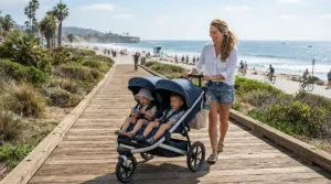 Strolling along a paved beachfront boardwalk with a twin jogging stroller for infant twins.